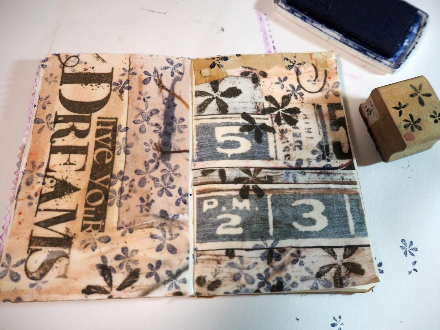 I started by added rubber stamping on top of the fabric . . .