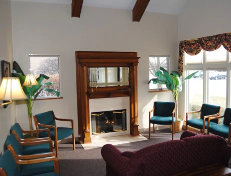 Comfortable reception area with a fireplace and beverage service