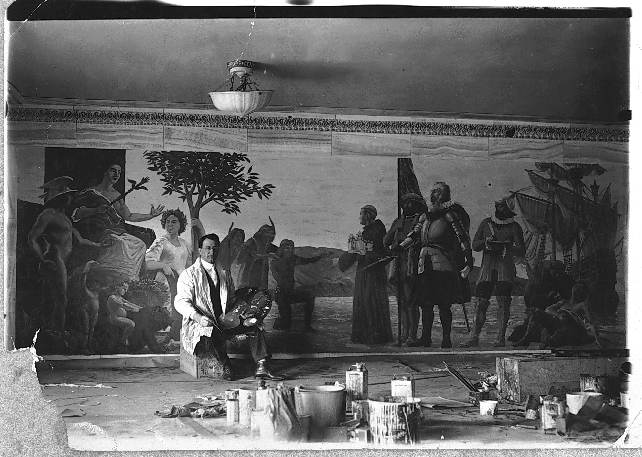 This publicity photograph shows Fausto Tasca completing work on a mural for the Farmers' and Merchants' Bank. The bank was located in Long Beach, California.