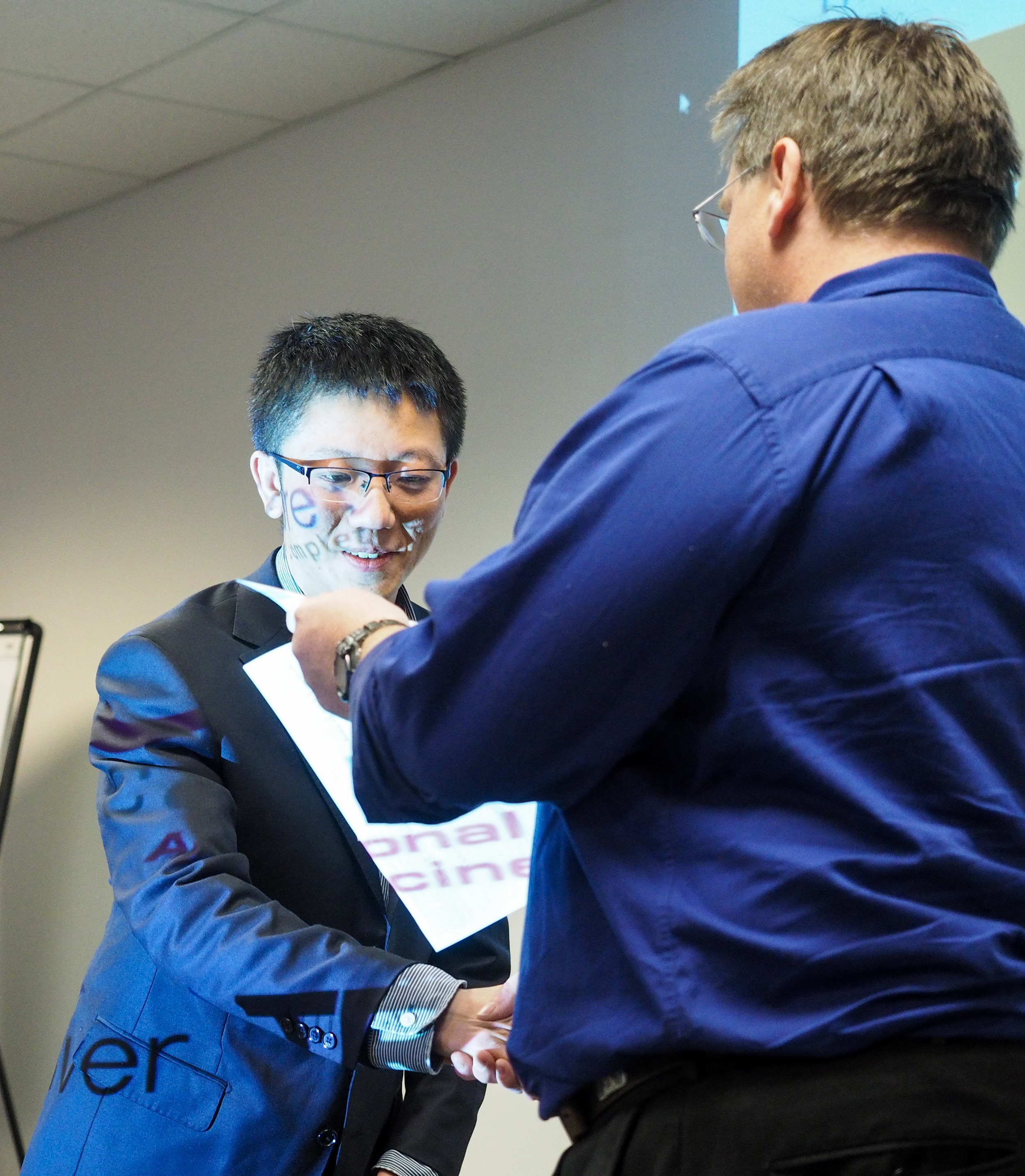 RTP DMDG Poster Review Chair, Steve Ferguson, presents Hao Cai with the poster award.