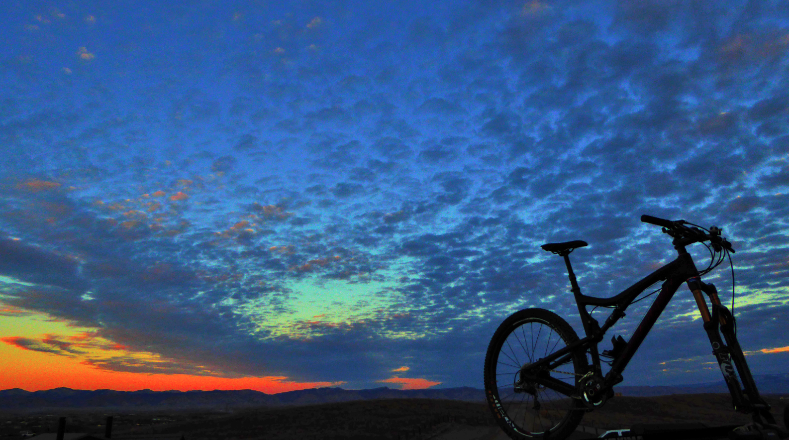 Bike siloette and orange blue sunset