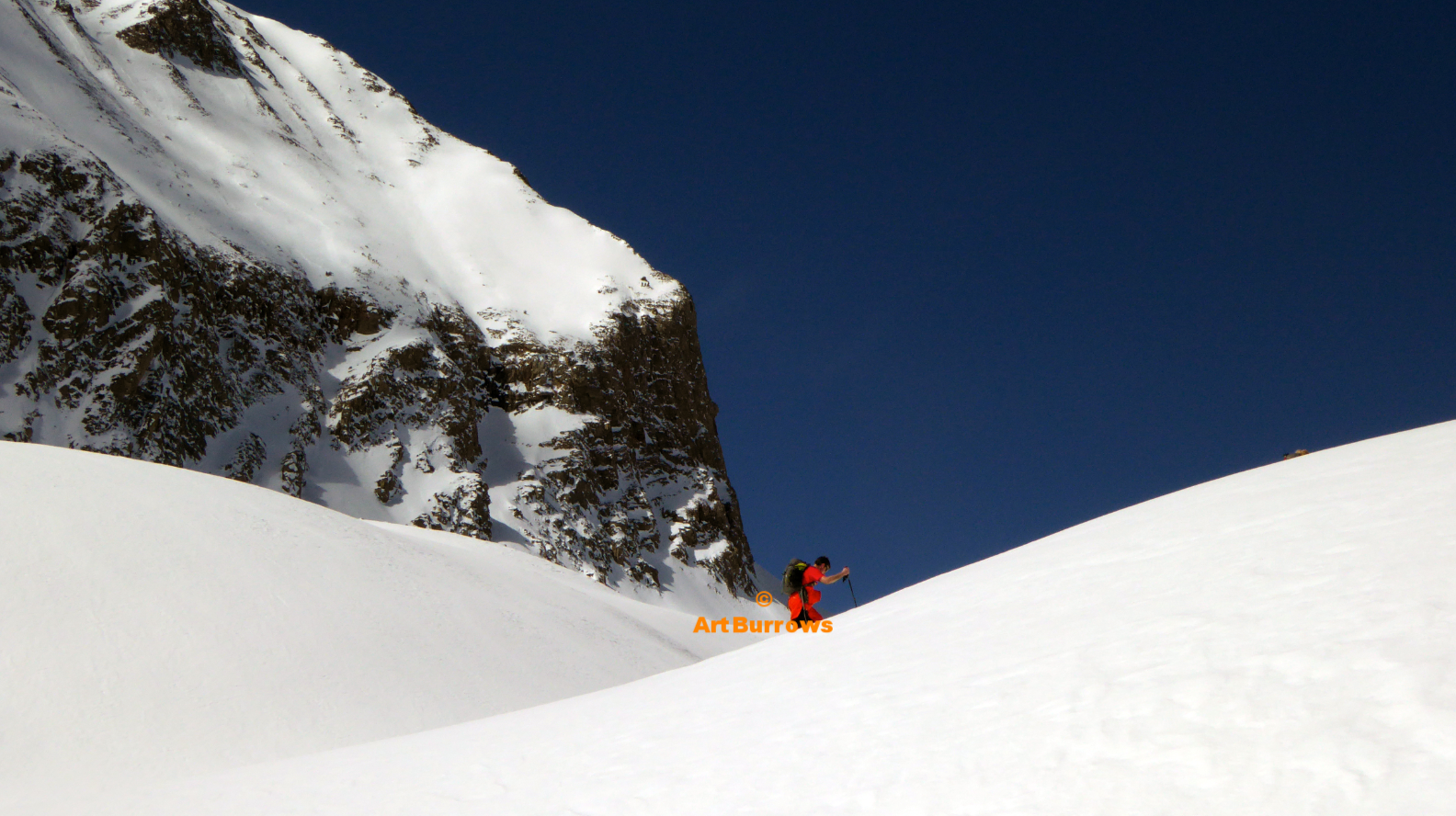 Lone Red Ski Tourer & Deep Blue Sky