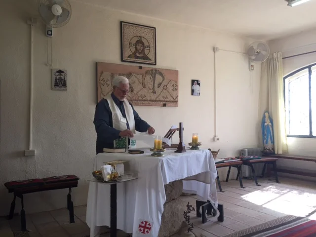 Fr Chuck preparing Eucharist at Mt Nebo, a special time together.