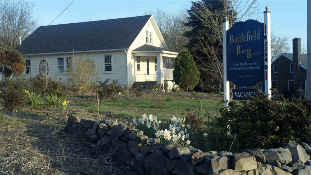 Roadside view of Battlefield Bed and Breakfast Inn's sign and the cottage