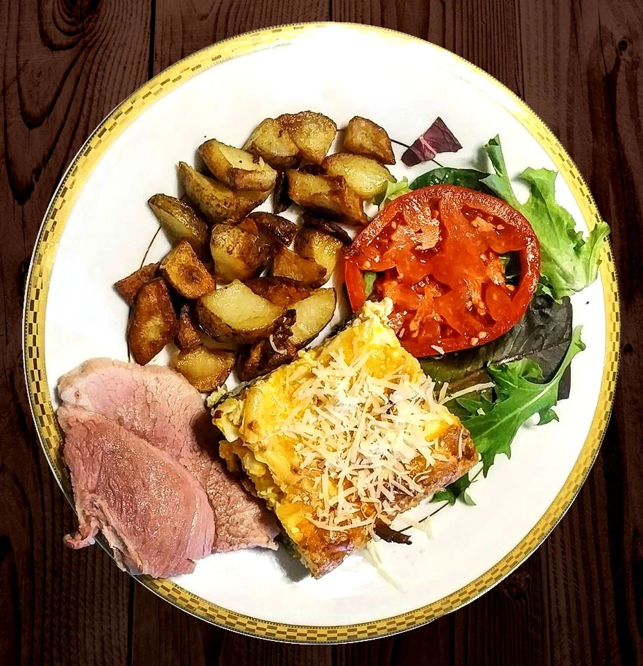 Three-cheese frittata with broccoli, onions, spinach and mushrooms, served with baked ham, farm potatoes and tomato, fresh from the garden.