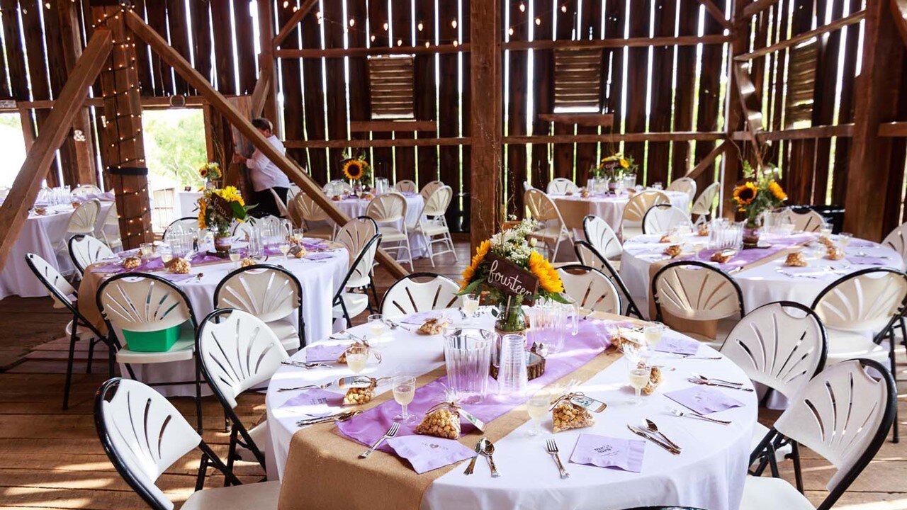 Historic Barn Rental includes 60" Round Tables with White Linens and White or White and Black Chairs