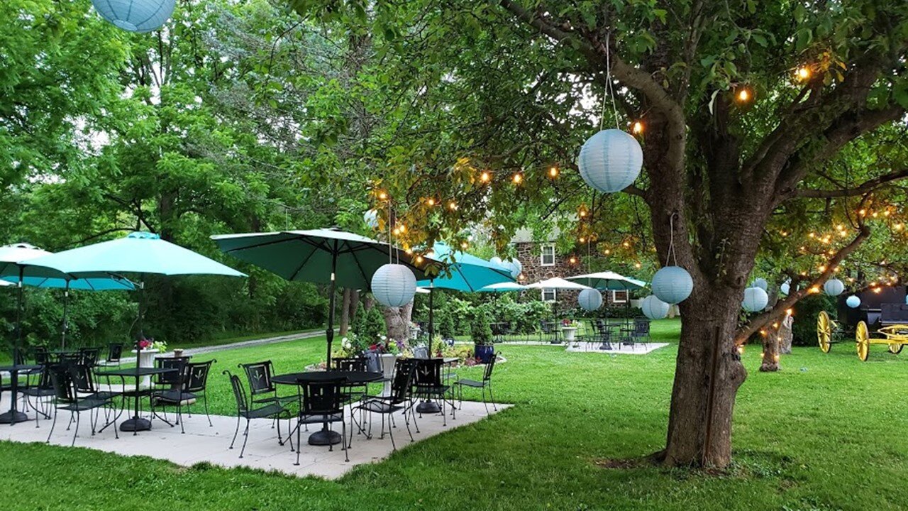 Front Lawn Patios with Wrought Iron Tables and Chairs, Umbrellas, Lights, and Carriage