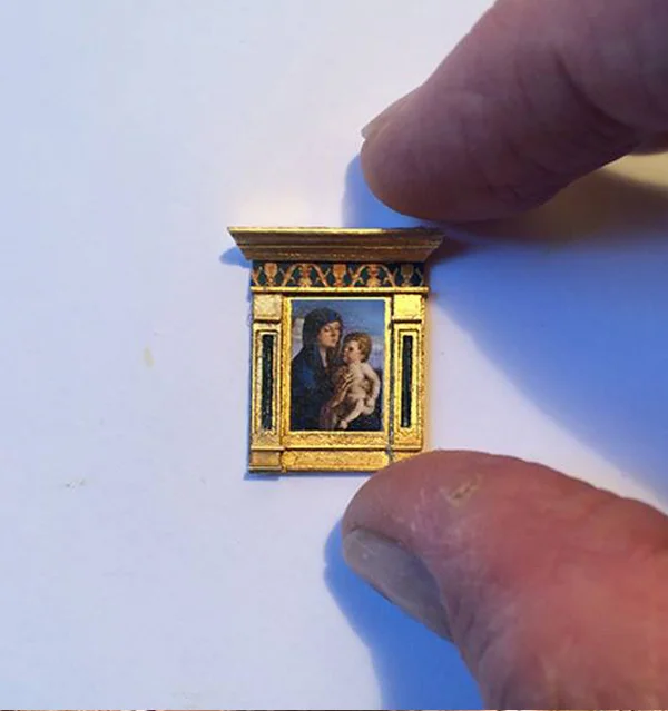 A miniature framed painting of the Madonna and child.