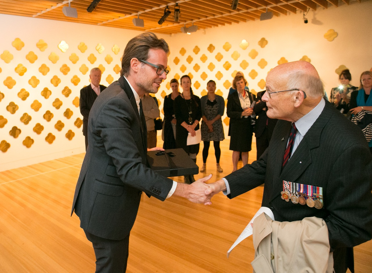 Keith Mitchell representing the New Zealand Sappers’ Association (RNZE) receiving his Max Gimblett ONZM Remembrance artwork from Paul Baragwanath, Project Founder. Photography by Michael Hall copyright Te Papa Tongarewa.