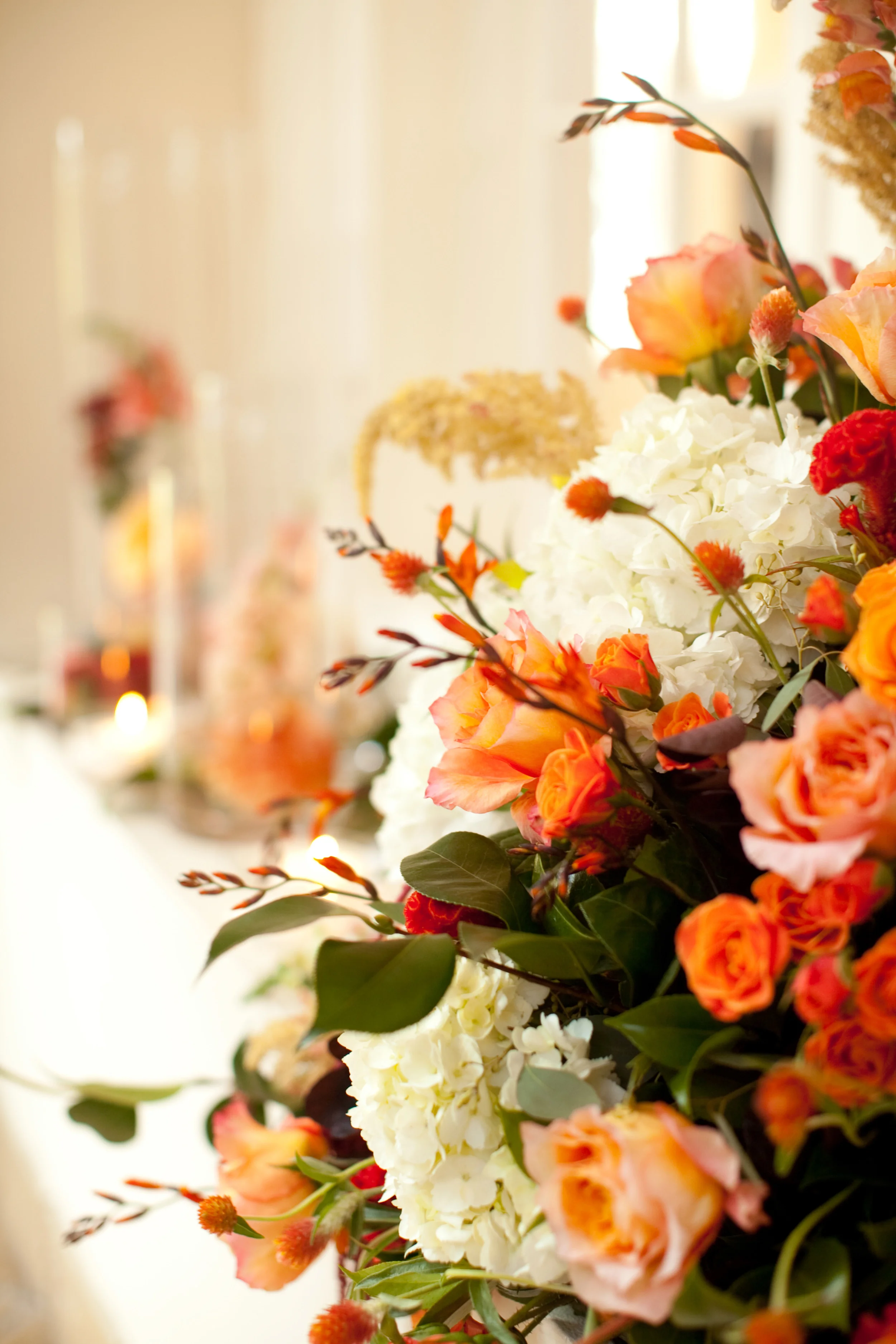 Fresh floral centerpieces in creams, pale oranges and rusts.