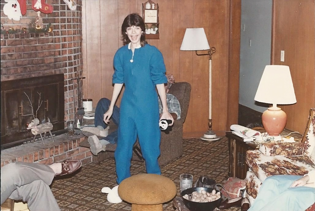 Yes, my love of footed jammies is legendary. I'm actually wearing some right this very minute. Go ahead, it's ok to be jealous. It's also okay to be jealous of that lovely couch. Oh, and notice behind me, my Dad's homemade slippers that he crafted himself from the hide of a sheep or some shit. Ugliest fucking slippers ever, and I swear I think he wore those till he died. 