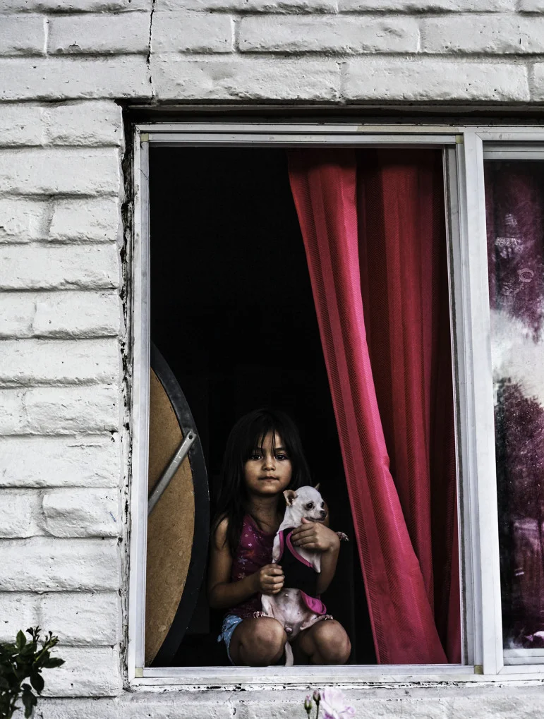Nata, Central City neighborhood. Nata is a quiet presence in the neighborhood—perched in her bedroom window.