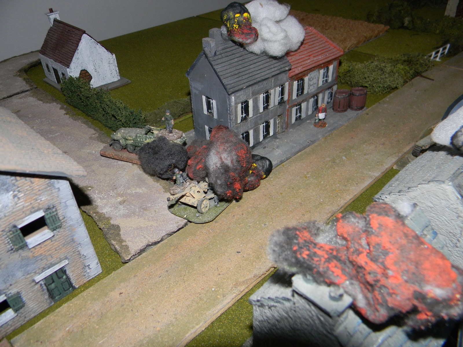 The British started with a "stonk" by off-table artillery right on Avaux village which took out the Germans' one and only PAK40 anti-tank gun and prime mover, killing all the crew including their commander (Big Man No.3). There were also casualties in the buildings across the street - not a good start for the German player.