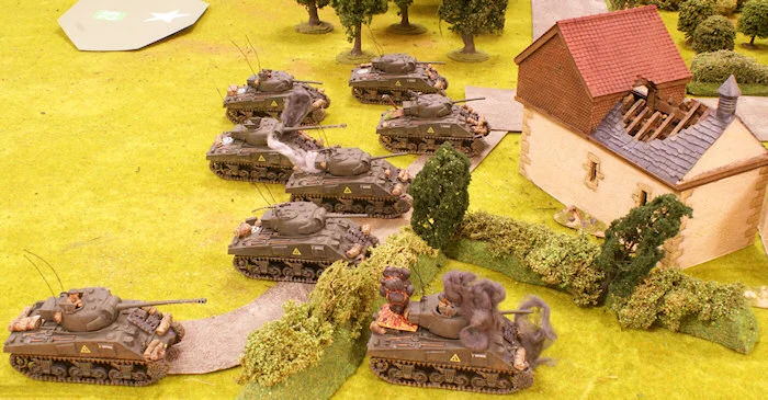 The tank killer team fires at another Sherman of the platoon and hits the engine.