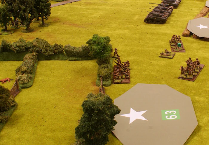 On the left flank the 2nd platoon under command of Lt. Oikswoth advances towards the woods. The platoon is ambushed by two groups of Panzer Grenadiers. One of the sections withdraws.