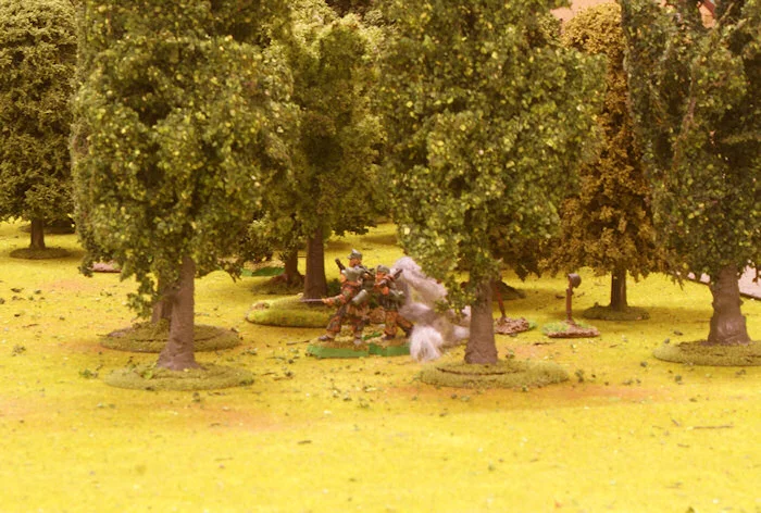 The woods are poured down with shells from the Sherman platoons.