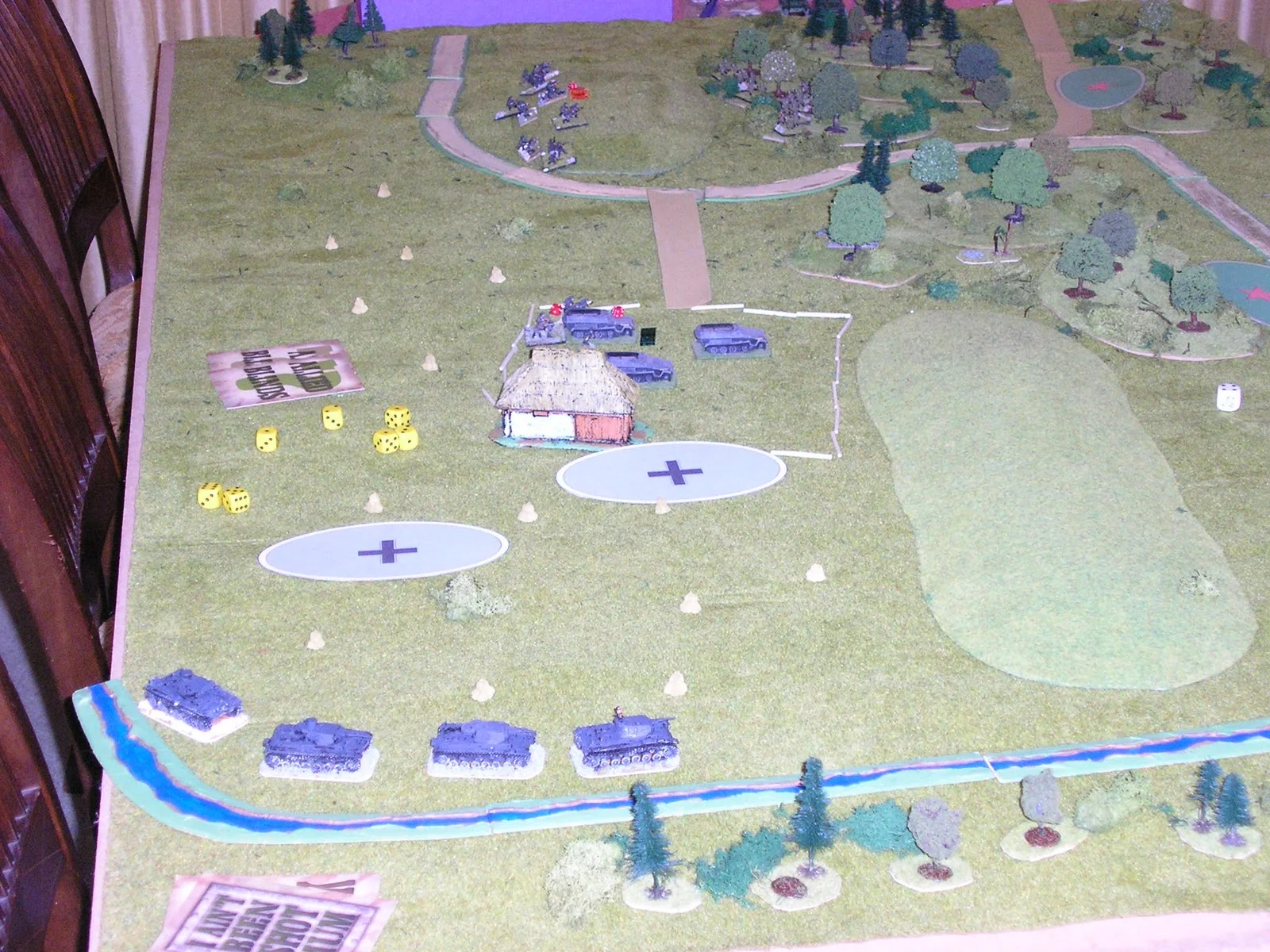 A German 1st platoon half track is immobilised in the centre