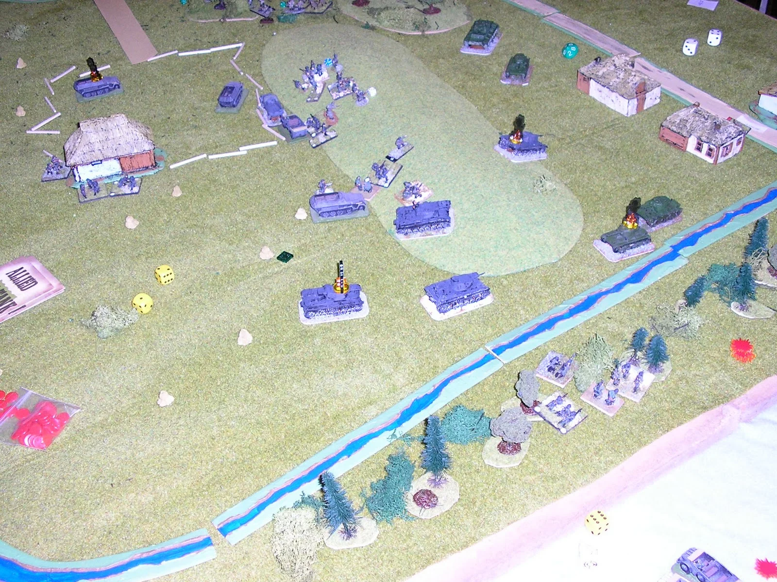 Soviet armour has paralysed the German advance (flanking fire hasn't helped) but one T-26 has already fallen to a Panzer III and an infantry section with accompanying AT rifle have crossed the stream to try to work to flank the remaining right hand T-26 - the destroyed tank markers are Paul's Litko markers.
