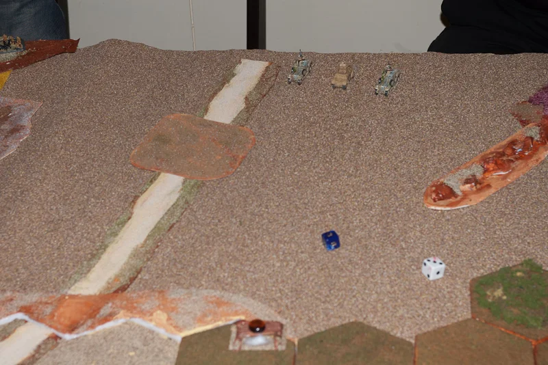 The unfair gunfight. Vickers hiding in the green brush by the white dice.