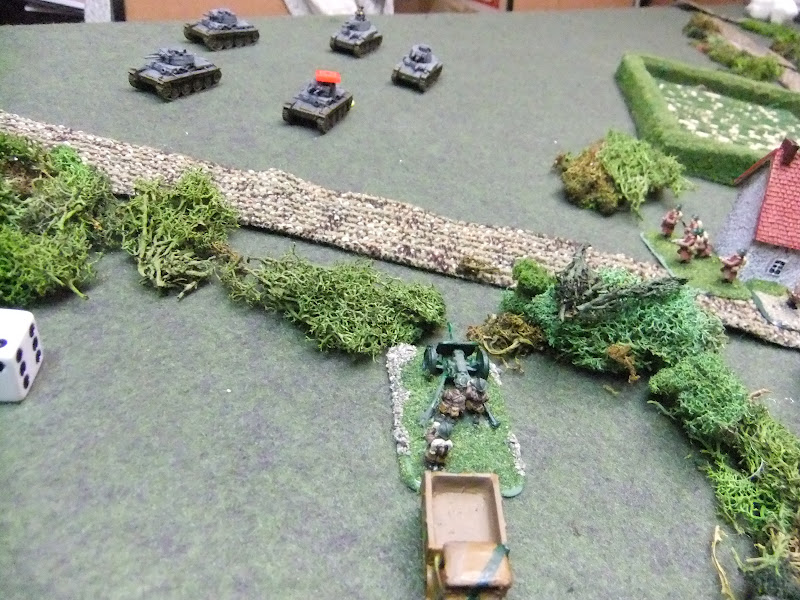 Panzers flank the town, the French At gun got one shot off then died under a hail of counter fire