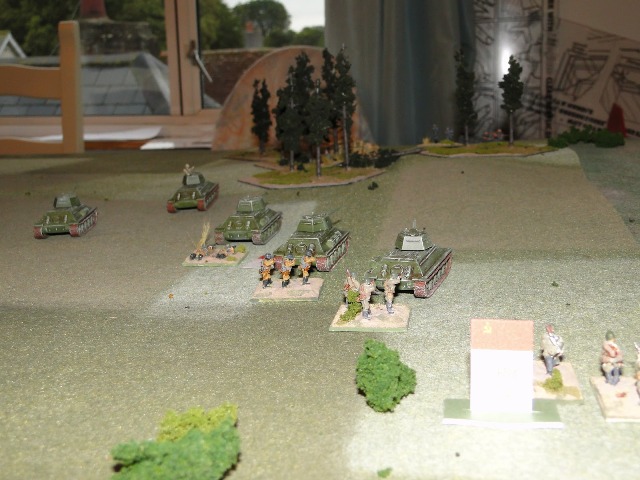 Soviet armour fires High Explosive on the wooded hill: two T34s roll a six in the attack, a third rolls double six. It's all over at the wooded hill as the survivors lose their bottle and retreat to the far side of the hill