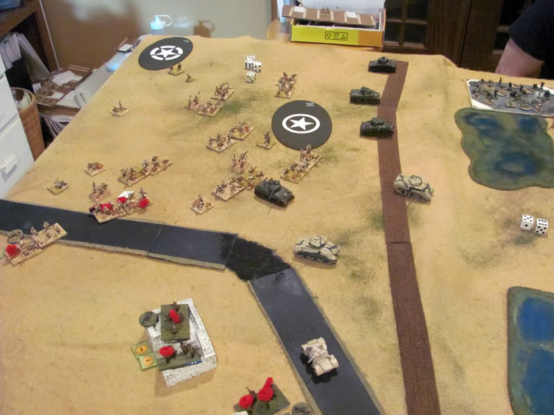 Italian Blackshirt infantry attacks from the vluster of buildings across the bridge