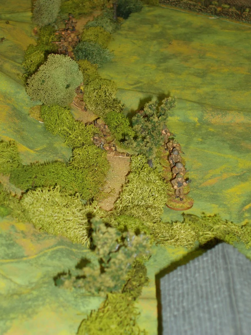 With the platoon commander dead, a corporal steps forward and tries to get the British sections into position to win the fire fight.