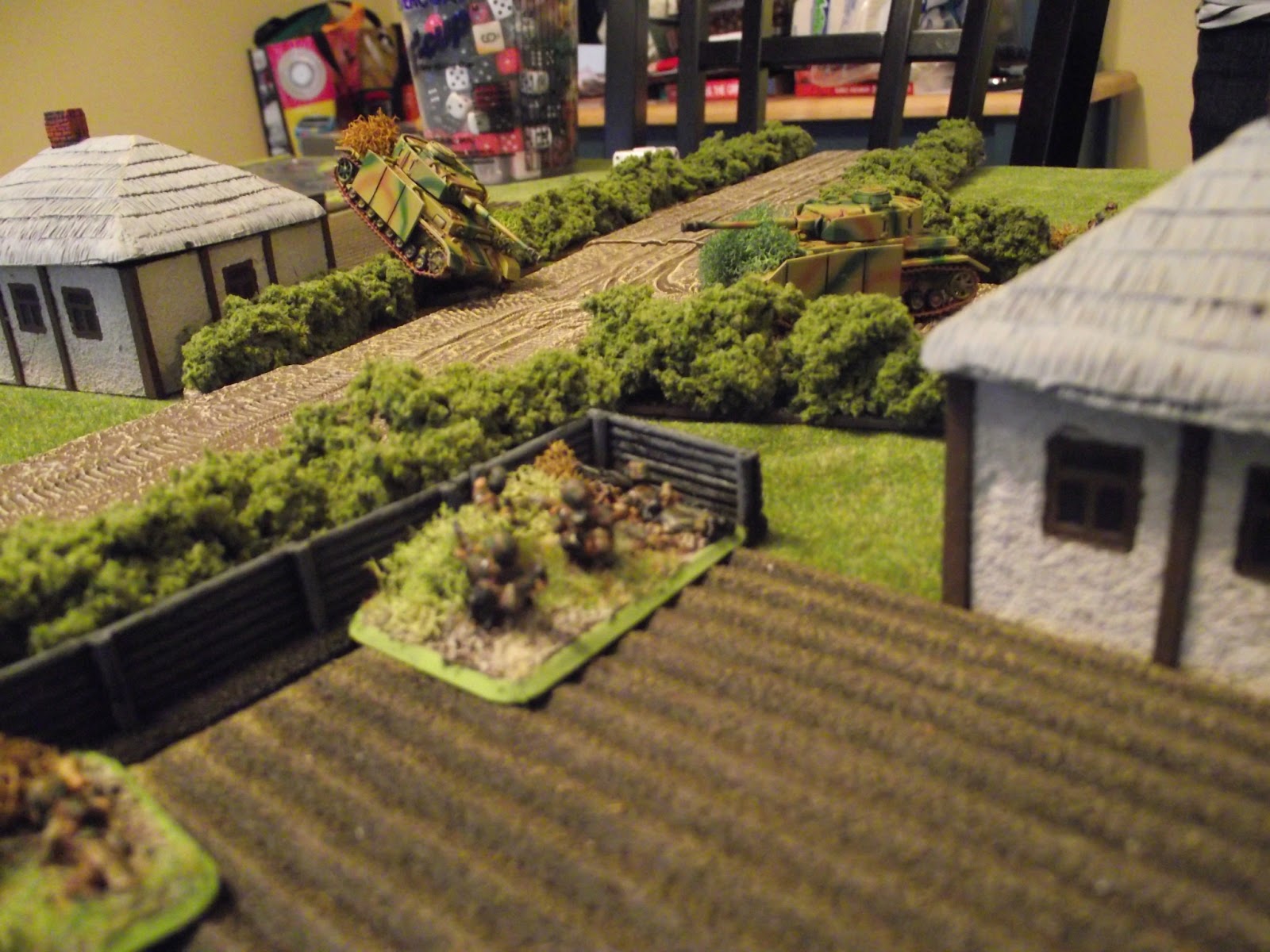  A shot of the German armour moving around. The stuck Panzer on the hedge is bogged down whilst trying to cross. The other is starting to look for targets.&nbsp; 