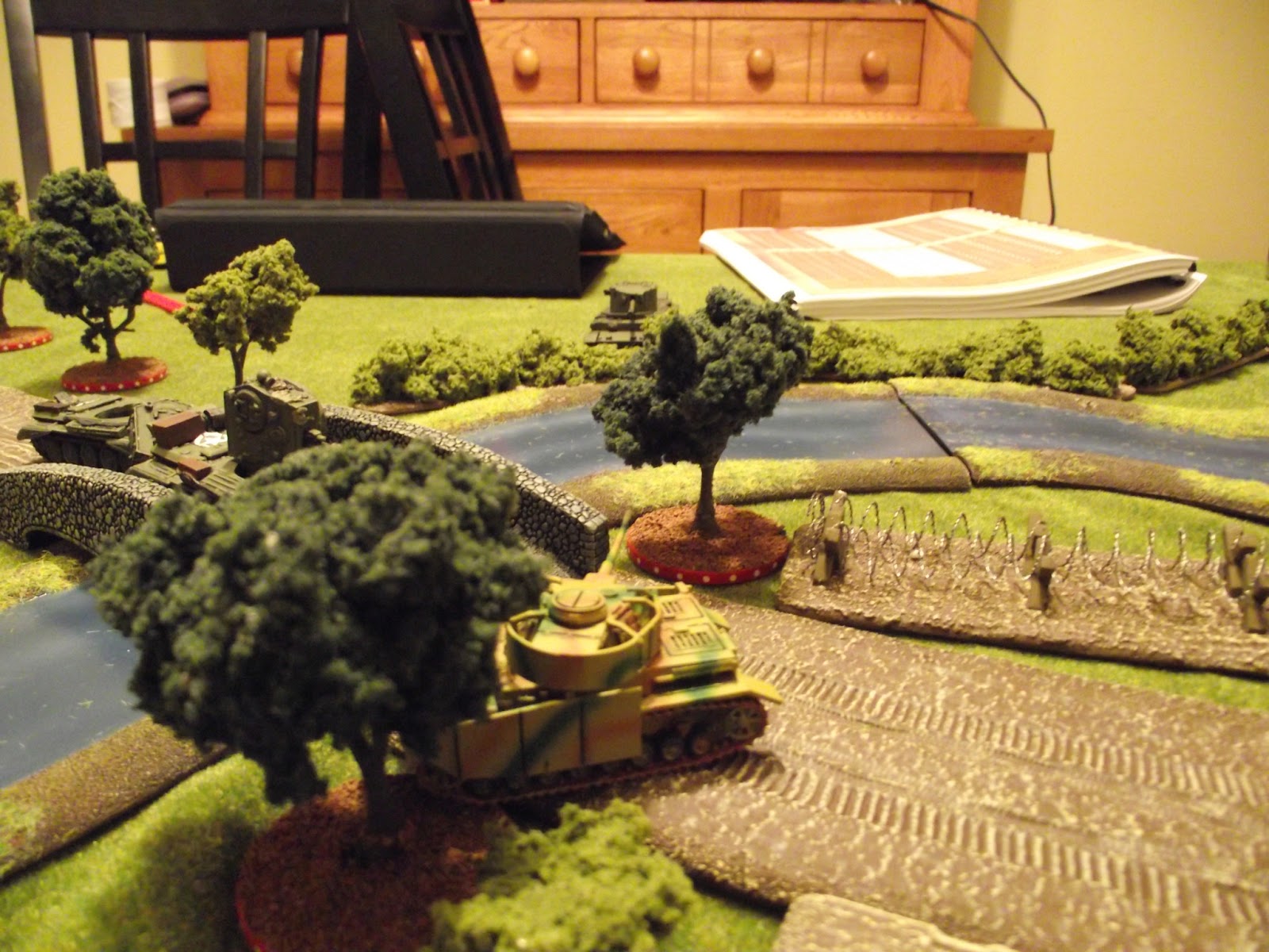  The British Challenger tries to end the game by shooting the Panzer IV from the side, but somehow only manages to knock its track off. The return fire forces the Challenger to admit defeat and move away. It beat my defence dice by one, and although 
