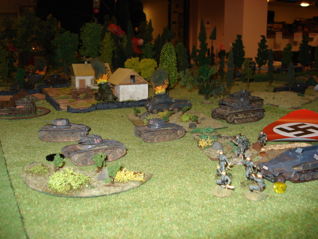 German armour rush up the middle of the board, past the farmhouse and the burning wrecks of both a German and a Soviet armoured car