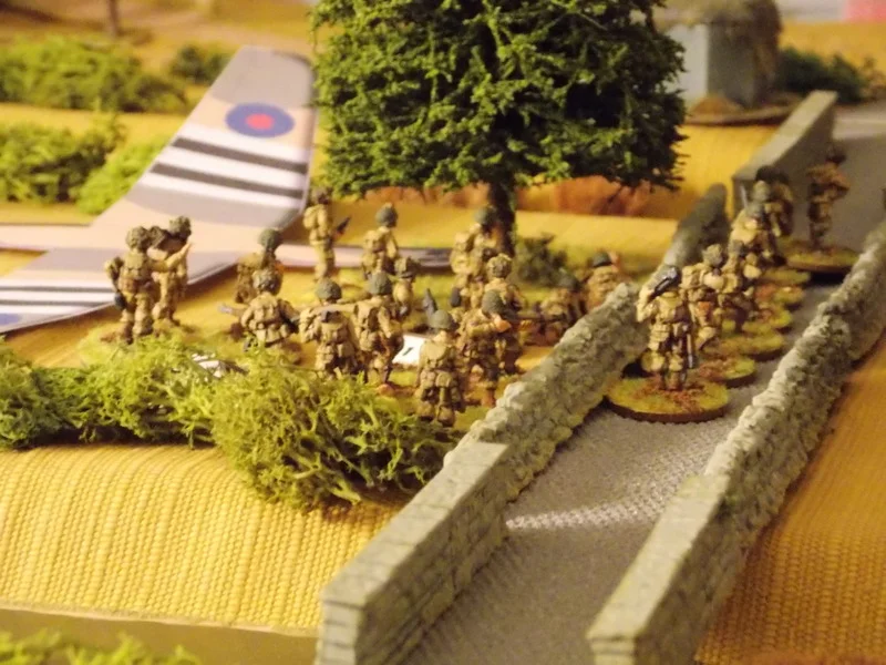 15 Pl voluntarily deploys for the Big Men to remove shock. The Breda MMG in the pillbox jams. LCpl Pratt takes the initiative and leads the unaffected section across the bridge into an assault.