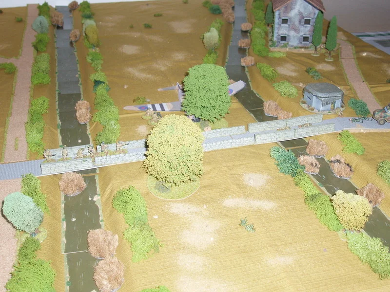 Lt Withers knows he must now retake the pillbox and orders the section at the southern end of the bridge to retrace its steps.
