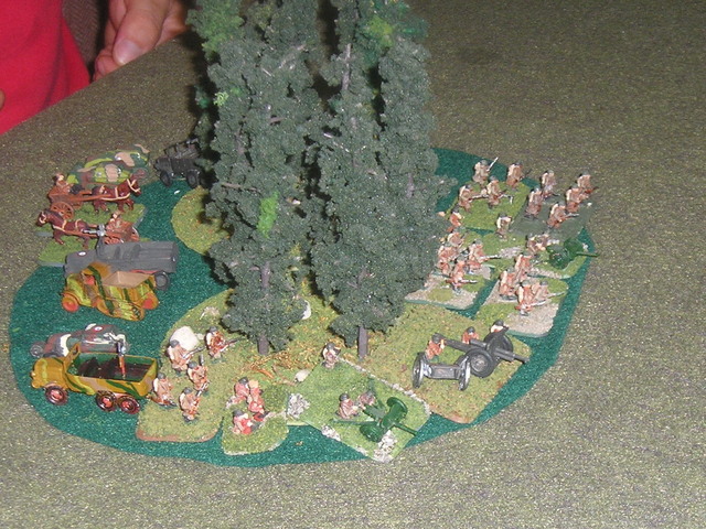 French infantry and support weapons mass threateningly in the centre, with three armoured cars in support. They would do little in the battle.