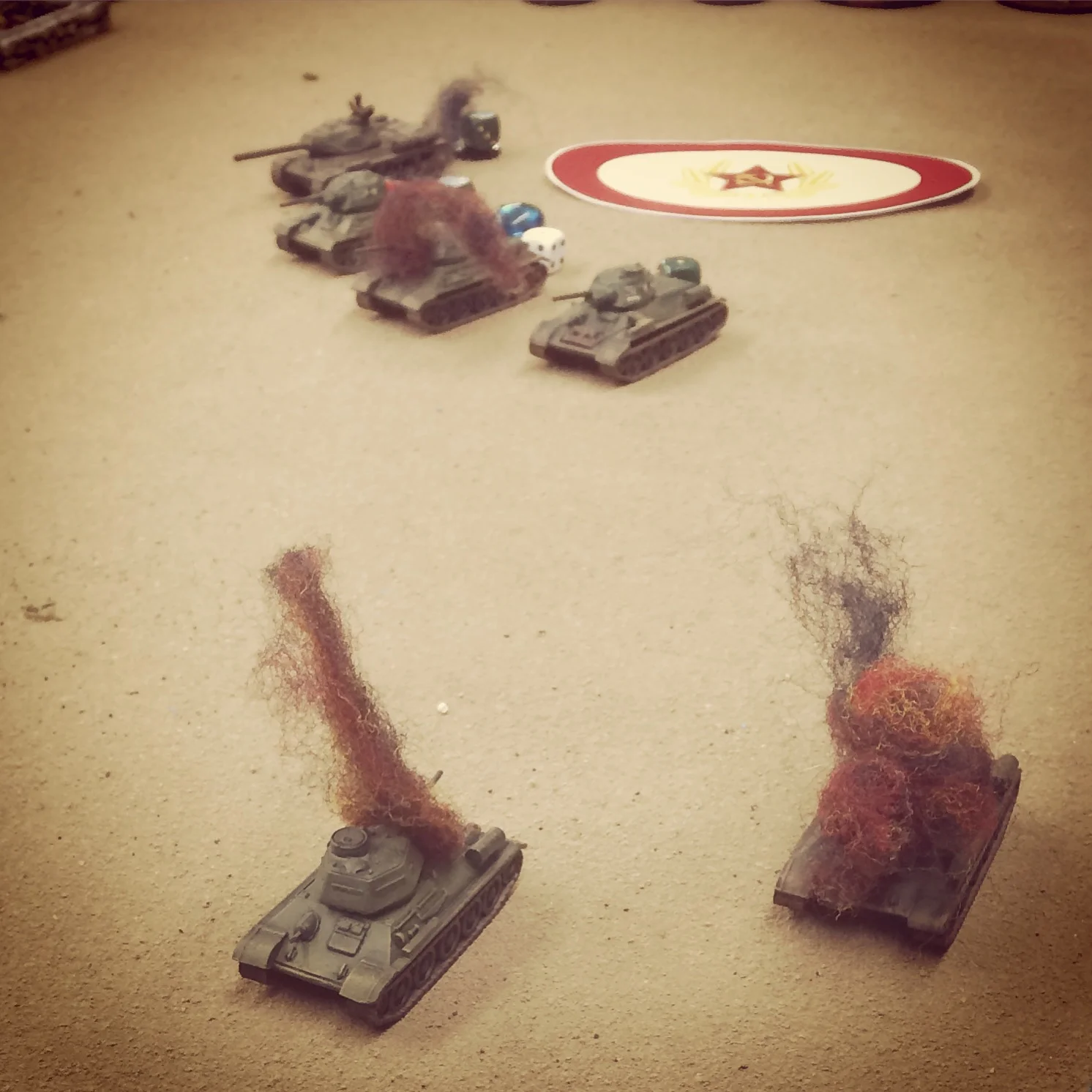 The first wave of Soviet armor burns in the field as reinforcements arrive on a blind to the rear