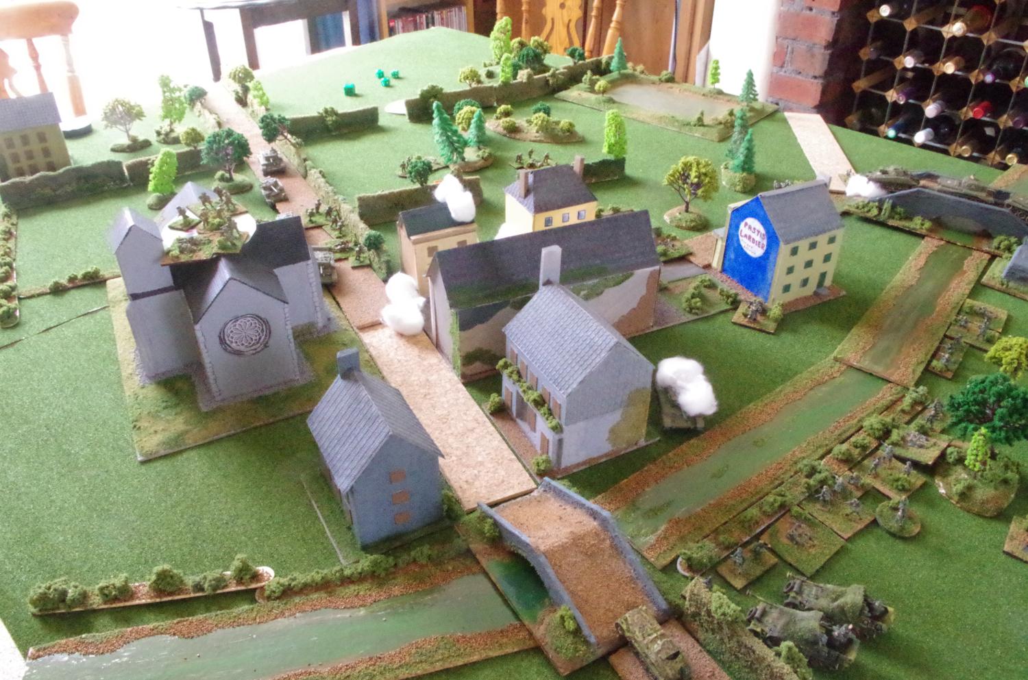 The British get bogged down as the village starts to burn