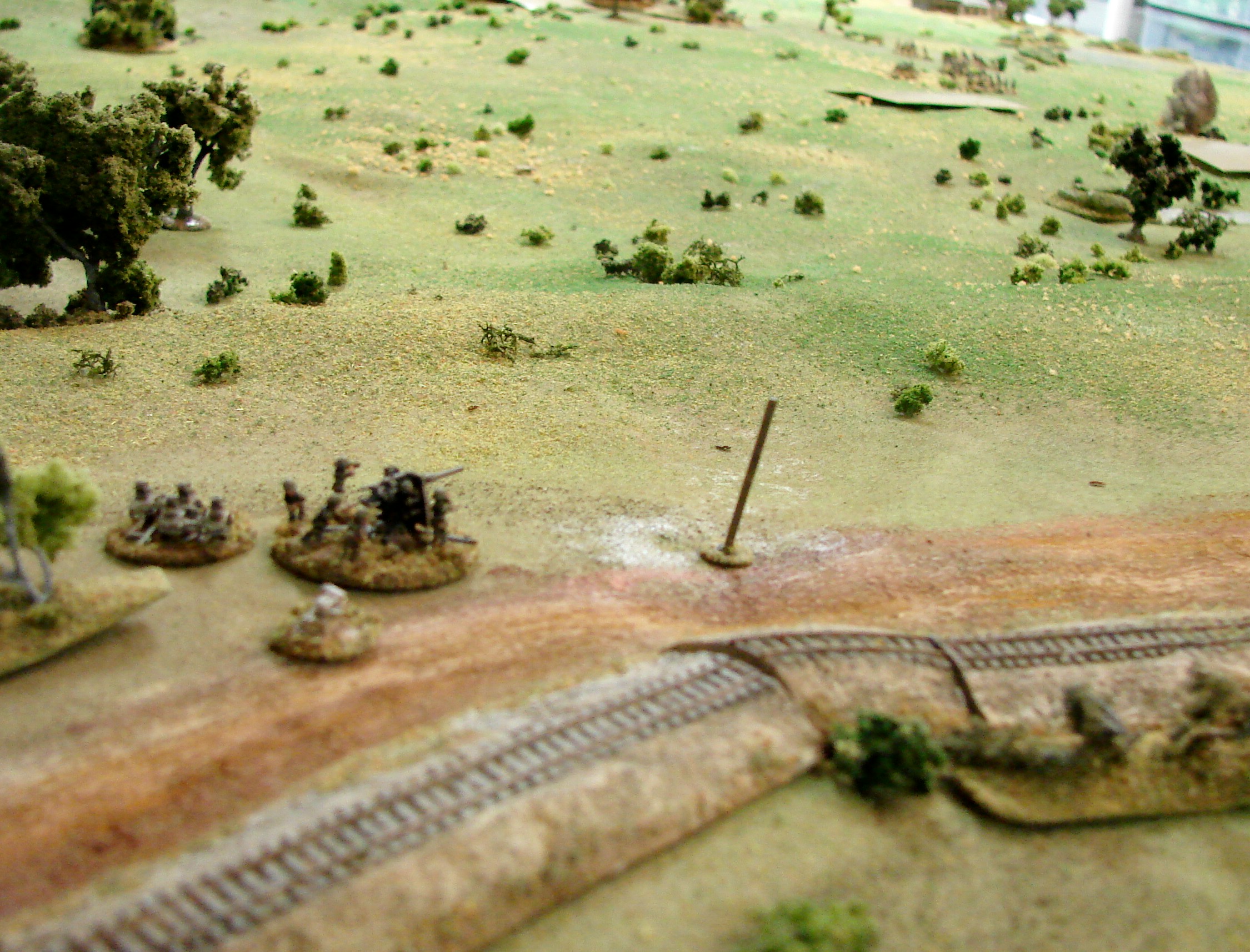 View from the 88 This gives a nice idea of the topography of the table. The railway was elevated as was most of the main road from Ptytscha. Otherwise just scattered clumps of brush a few trees and marshy ponds & streams. The 88 has already taken out a T26.