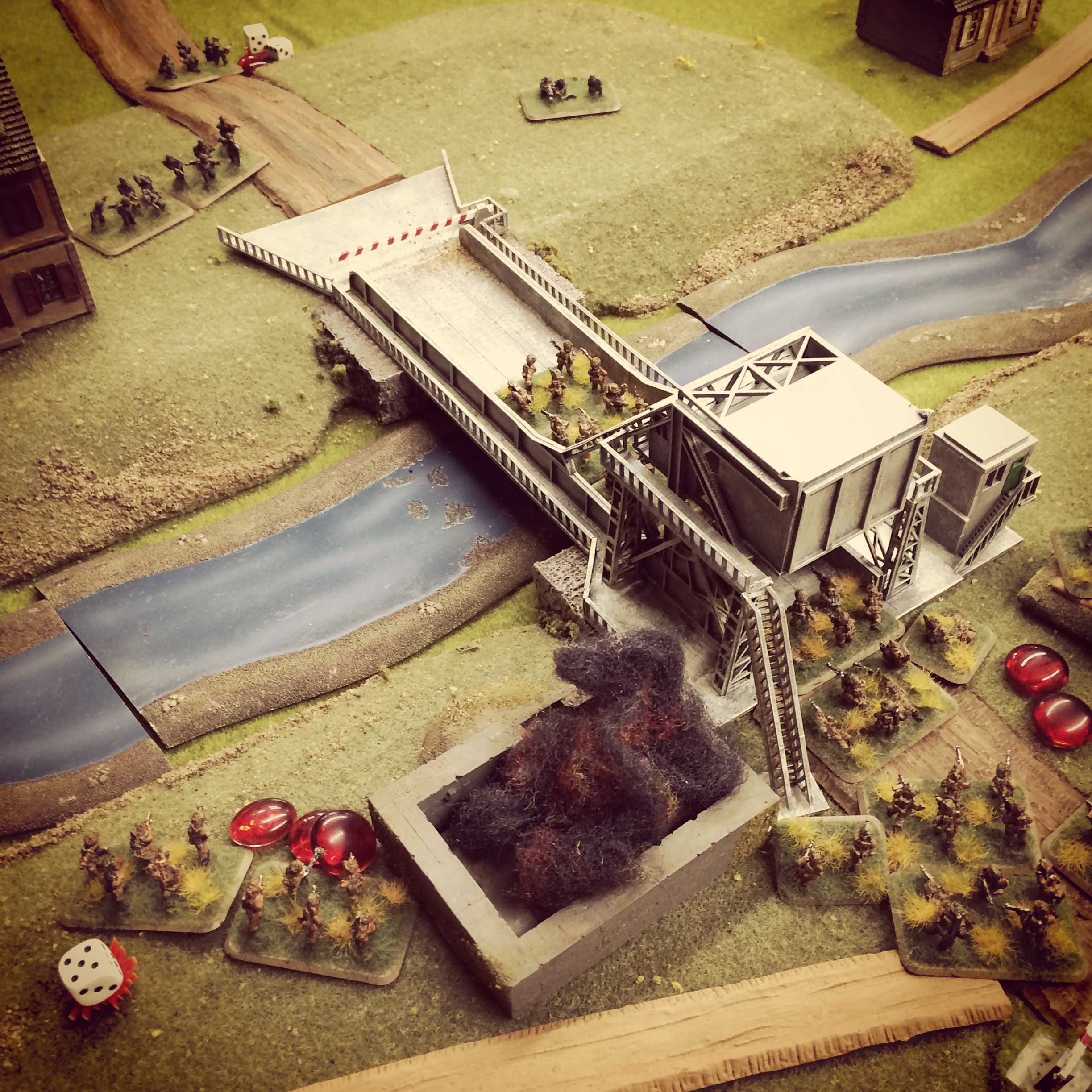 The bunker burns, the British head over the bridge but take shots from German snipers