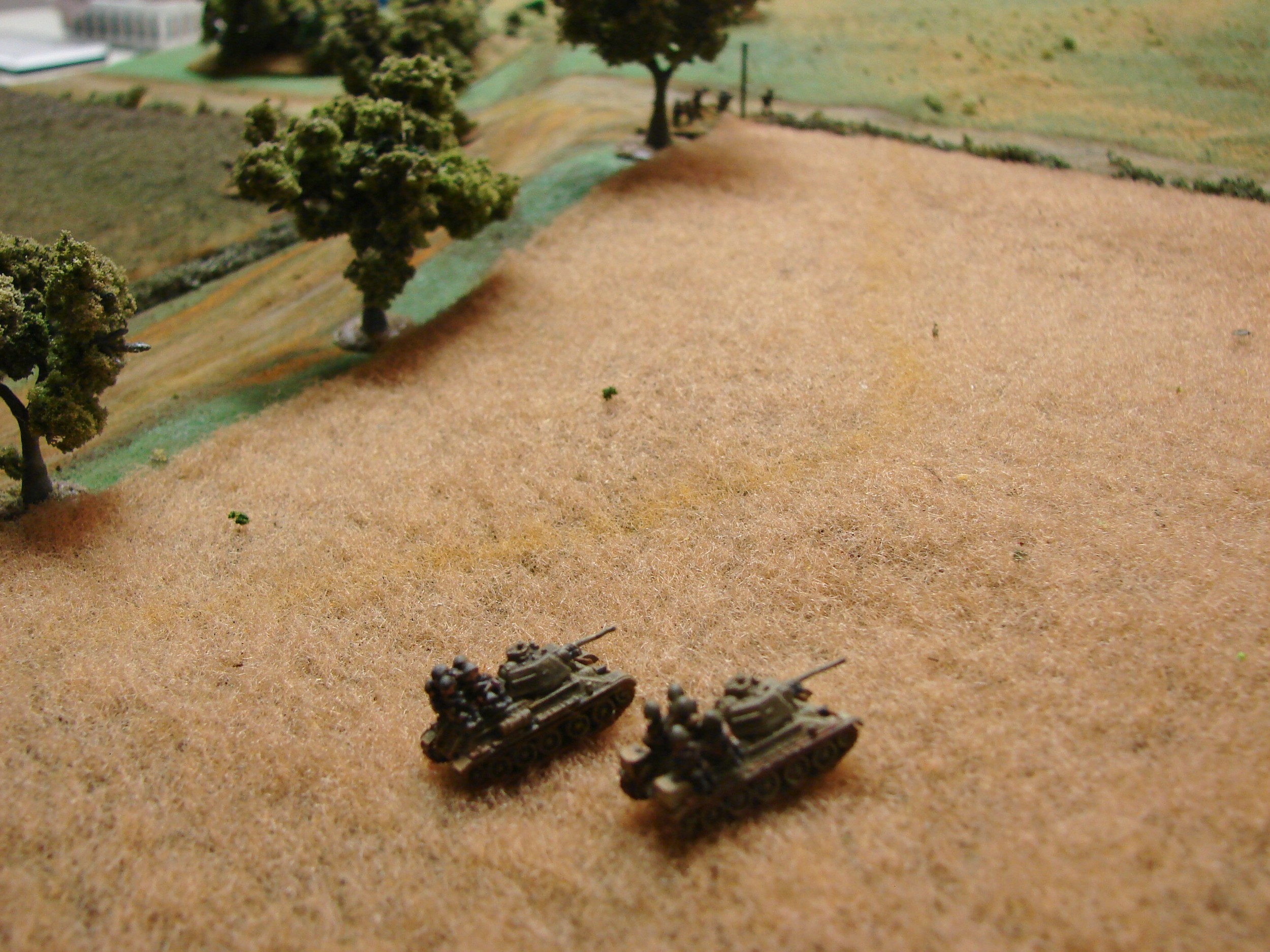 First Russians Identified In this game the Russians came in at different times. The variable deployment really made a big difference and the Germans also managed to get the Stugs on within 3 turns. Here is a couple of the T34/76s with tankriders. The other T34/76s and their riders are coming in near the center of the table edge to the right of the picture.