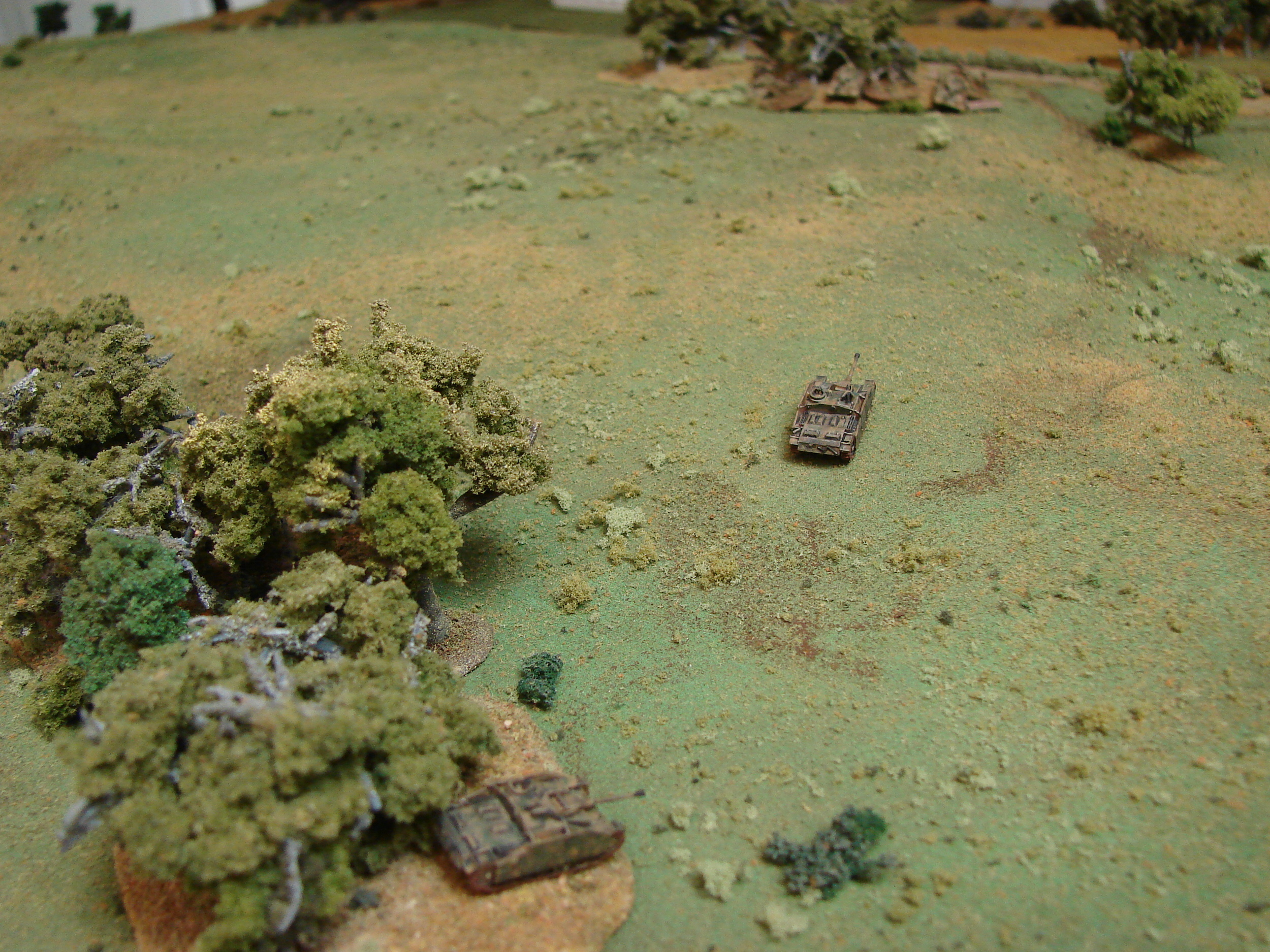 Stugs vs T-34s Two of the Stugs move to takeon the T-34s that have moved up to the light woods. The Stug on the right backs out of the fight to recover some shock points and one of the T-34s gets blasted next turn.