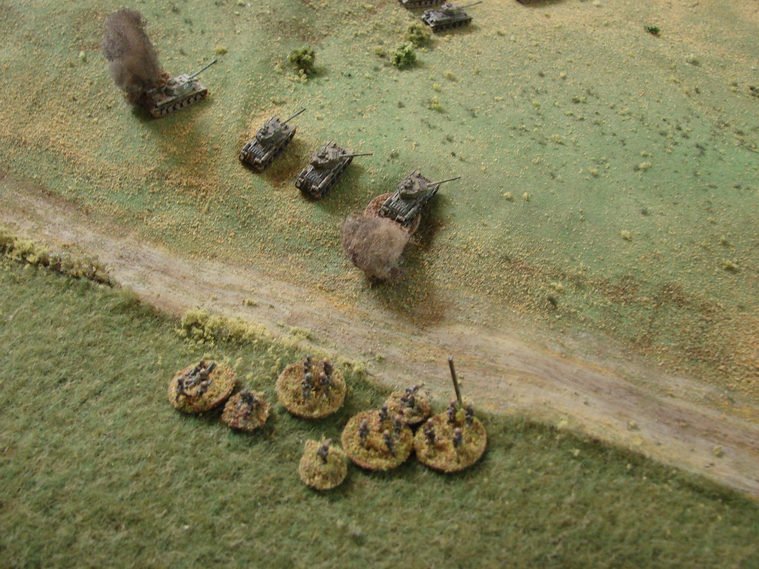 Grenadiers in the Rear The left flank grenadier platoon moves through the field to close assault, or at least 'faust, the Soviets. Two out of three miss and one T-34/85 is destroyed.