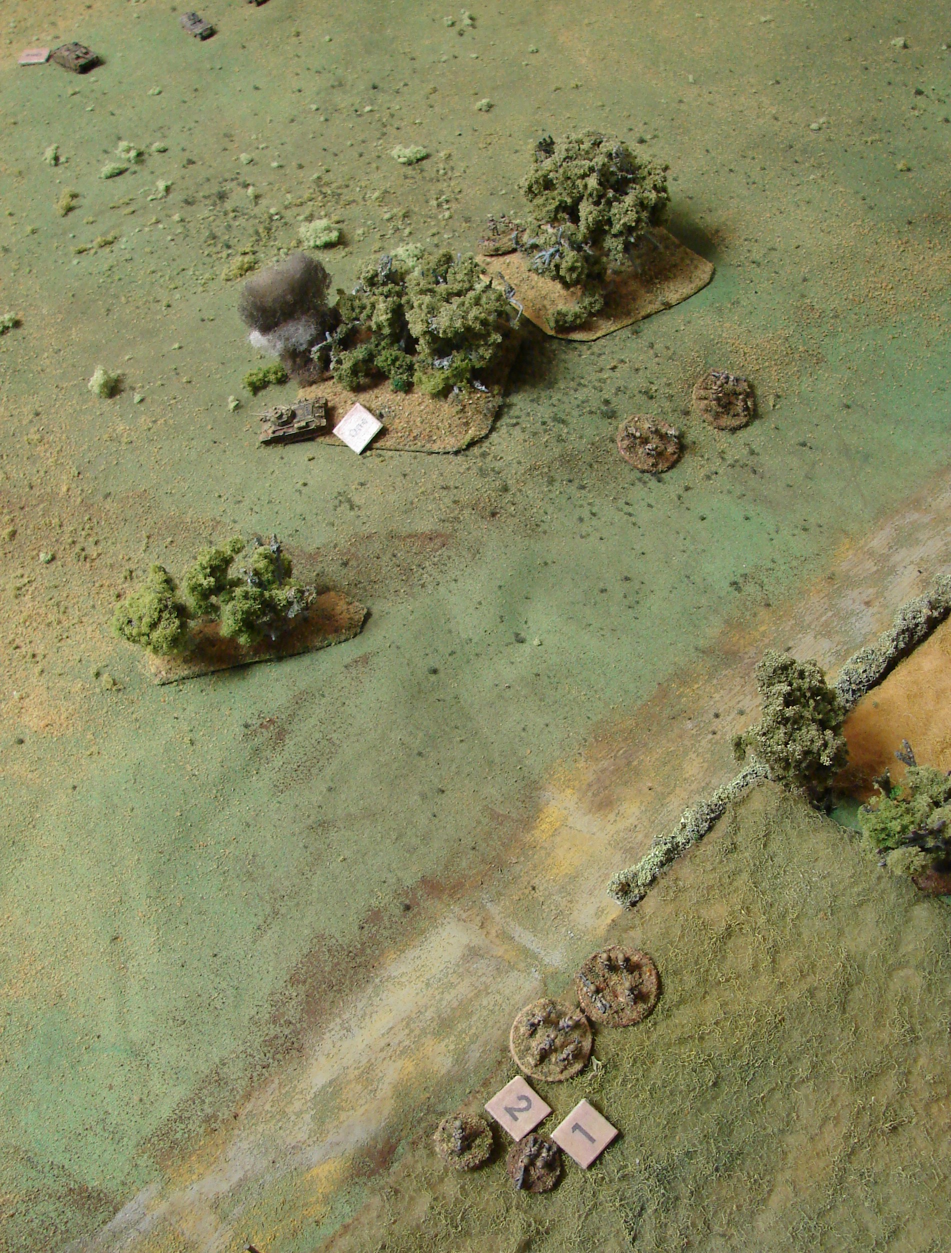 Remaing Russian Infantry Heading Back to the Center of the Board What's left of the Russki infantry moves back down to try to form a back up and find a CO. Two T-34s duking it out with the StuGs.