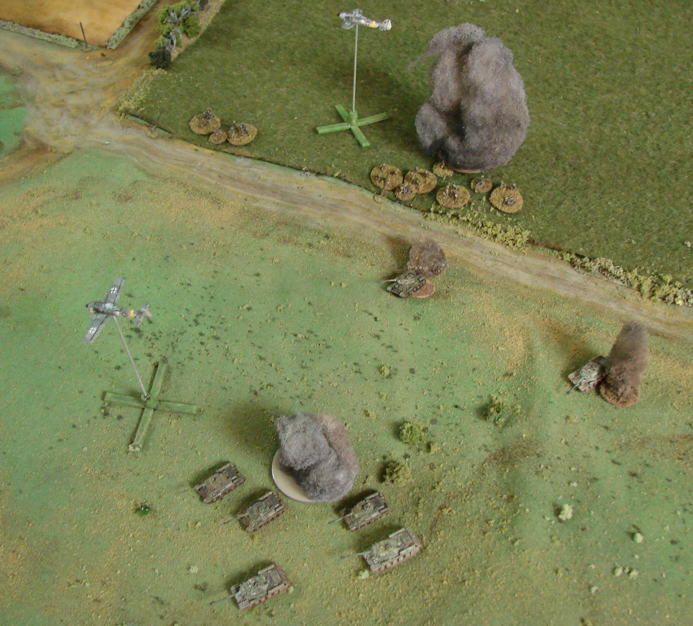 Non Denominational Smiting We finally did get an actual airstrike. When a card came up (one for Russians, one for Germans), we had to roll a '6'. After failing to get a 6 around a dozen times, we finally got the Luftwaffe to make an appearance. With such a confused battlefield, we just rolled to see what unit in the open would be attacked. The gaggle of Soviet tanks was the lucky target and one bomb landed right on target, destroying a T-34 and stunning another next to it. The other bomb went 10" off target, smack into the grenadiers, causing a kill and a few shock points.