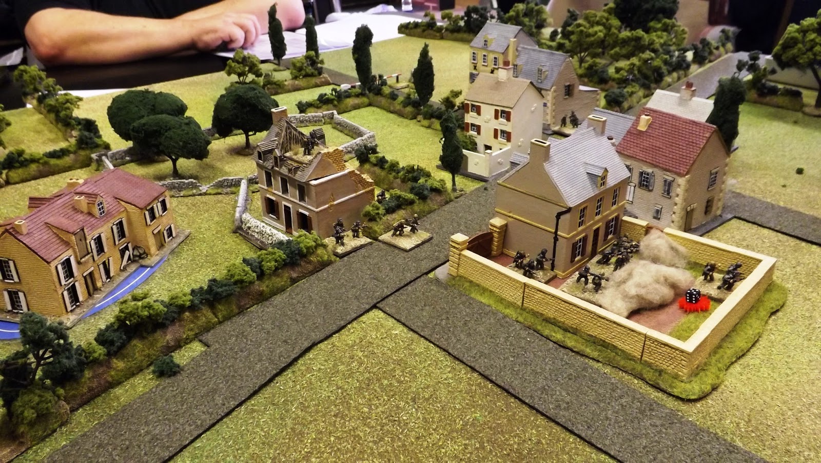 The first exchanges of close up rapid fire starts causing casualties and shock. The big house that formed the centre of the German defence at gr14 is pictured right.