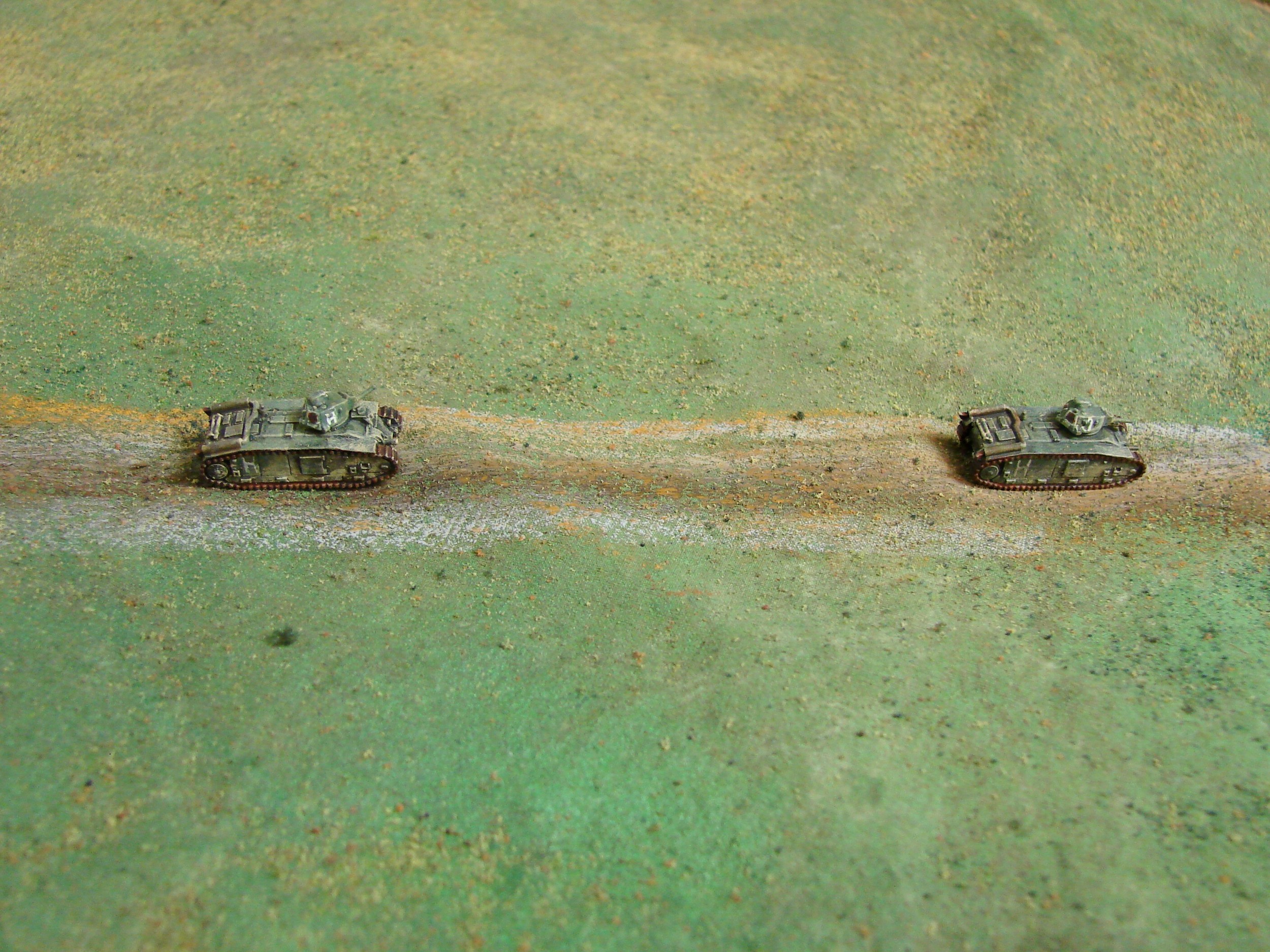 The first of the Char B We allowed up to four tanks to enter the table at a time, randomly selecting which pairs. They are slow tanks, and with the 'vehicle breakdown' card in the mix, there was a chance that they might not make it to the farm even without any enemy action. (CinC models)