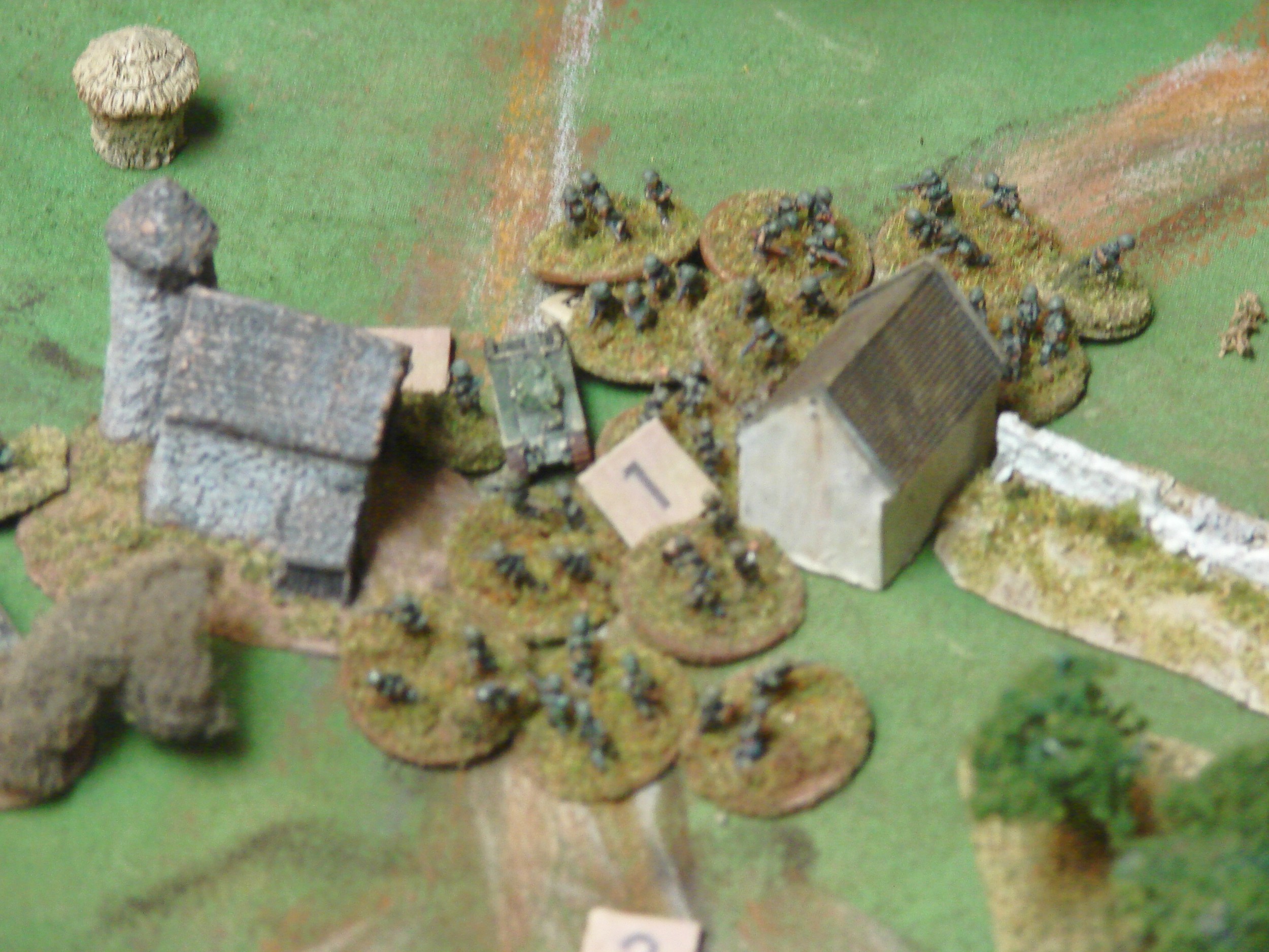 German Human Wave Not content with one platoon trying to pry open the stuck Char, the other platoon moves up. After a few turns of this the crew gives up. The other Chars were involved in a shoot out with the Pak to the right, which they managed to silence with MG and 75 HE fire. The relocated Pak from this position had moved around to the left to engage the Company CO Char. We decided to call it at this point since there were only three functioning Chars and they wouldn't be able to root out the infantry. The Germans lost two StuGs and two Paks along with an infantry gun and their transports. The Chars were indeed hardy. Four of them took over ten hits, the one in this picture took 16 hits before surrendering.