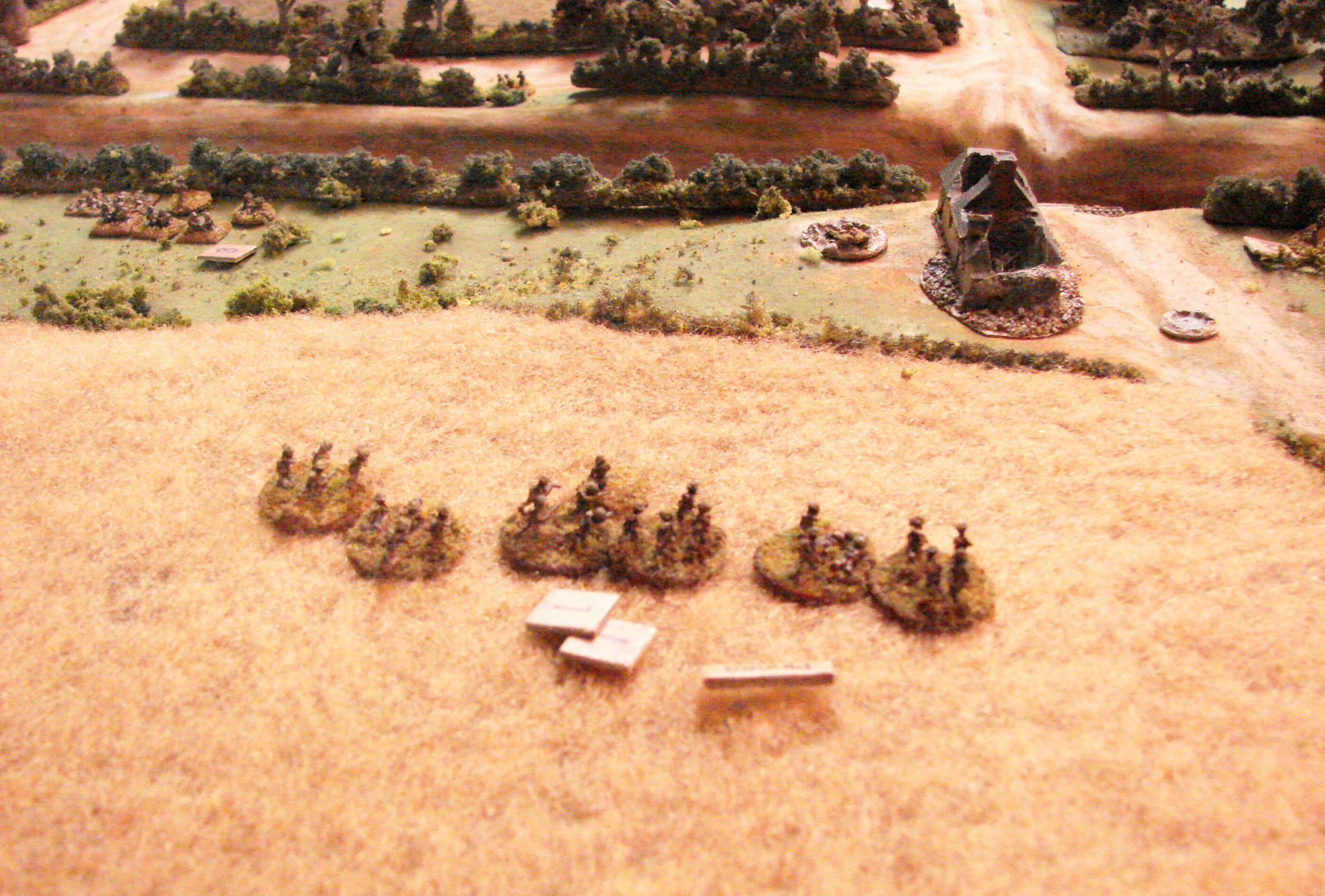 End of the game It was obvious that the Seaforths would not be able to get across the RR cut. They did have the remains of two platoons at the hedge line overlookng the RR though. The HQ squad was wiped out, the 1st platoon was down to one squad. The 2nd platoon was at 2/3rd strength. The 3rd platoon also at 2/3rd strength. The tankers had four of six Shermans still functioning - no Fireflies. Meanwhile, the German grenadiers had one good platoon and the other had taken over 50% casualties. Only one MMG and one Pak were in good shape. The Tiger was in the rear. Time for some more artillery!