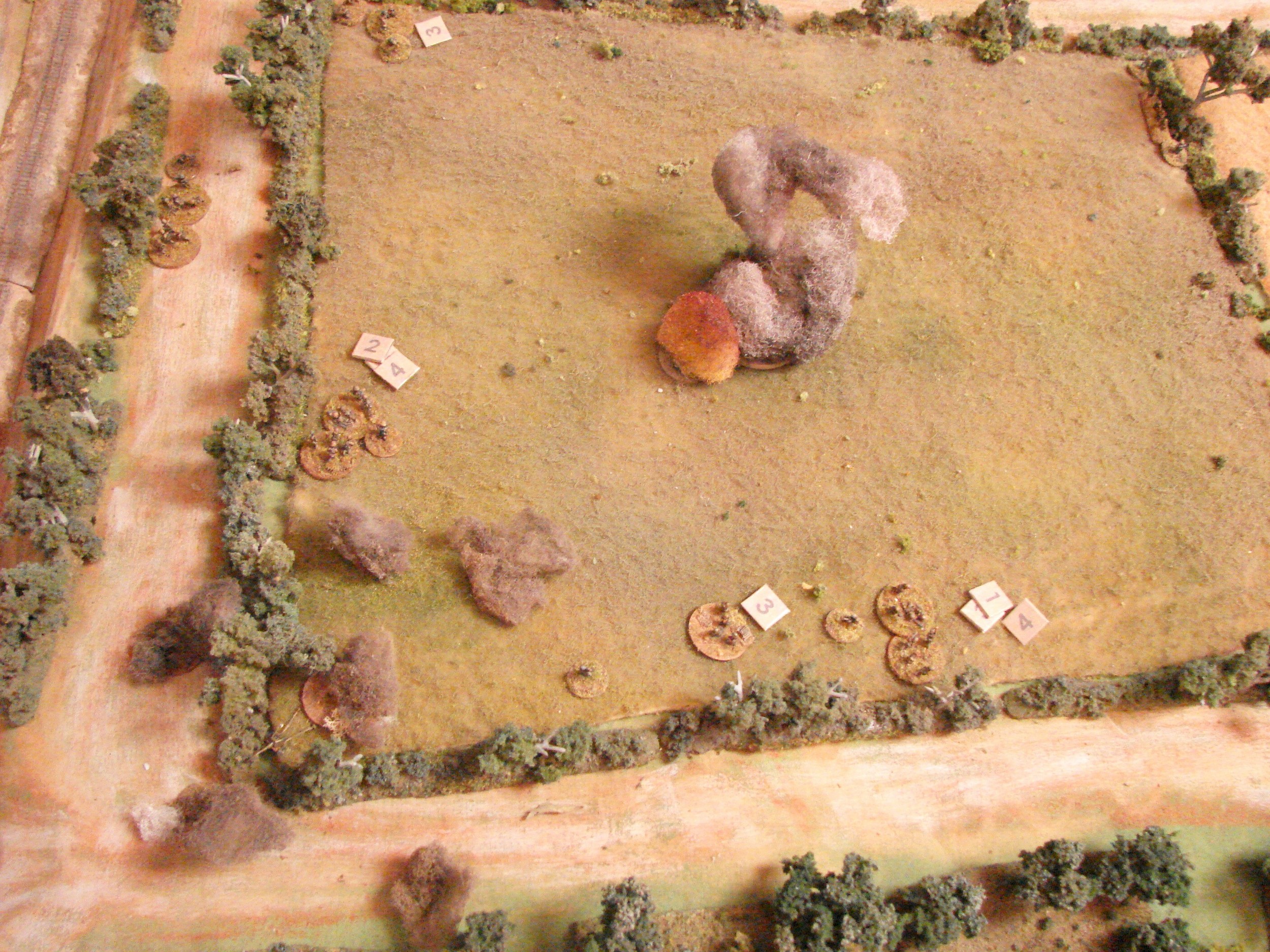 Fire in the rear. The 25 pdrs finally come down behind the German positions and a random event card comes up for fire started. The German line is really starting to falter now. The platoon leader is attempting to rally its retreating left squad. The left side Pak is out of operation. An MMG team is also being rallied by its BM