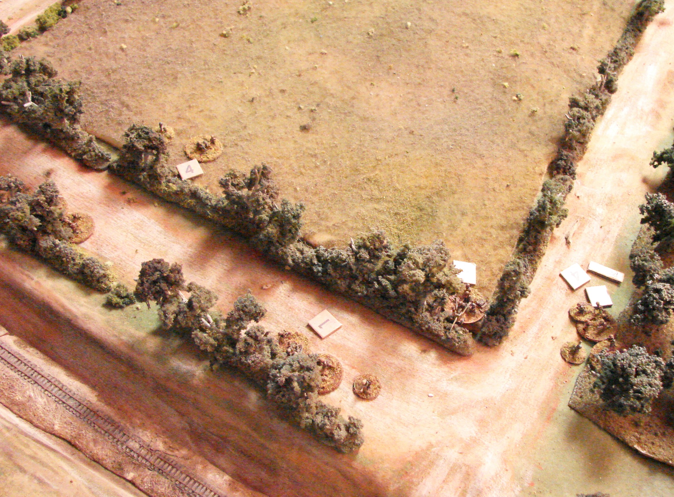 Germans taking damage Their leftmost squad has been forced back into the orchard. The Pak is in serious trouble and one of their MMGs has pulled back also.
