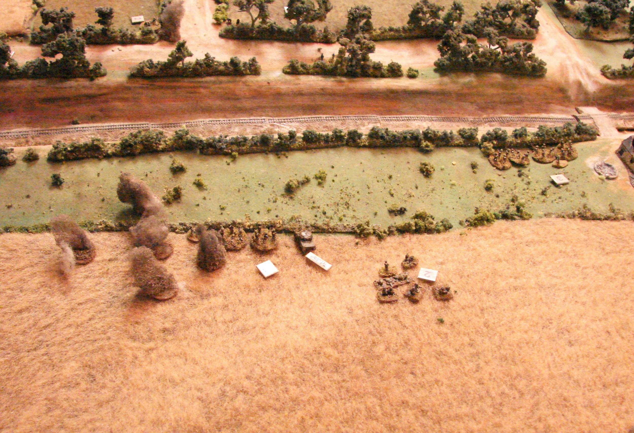 Mortar fire The Germans have very little in the way of artillery at this stage, but do manage to get some medium mortars to land on the advancing Brits. Meanwhile the 2" mortars of the Brits have been busy putting an occassional shock point on the MMGs. The 25 pdrs are still silent though.