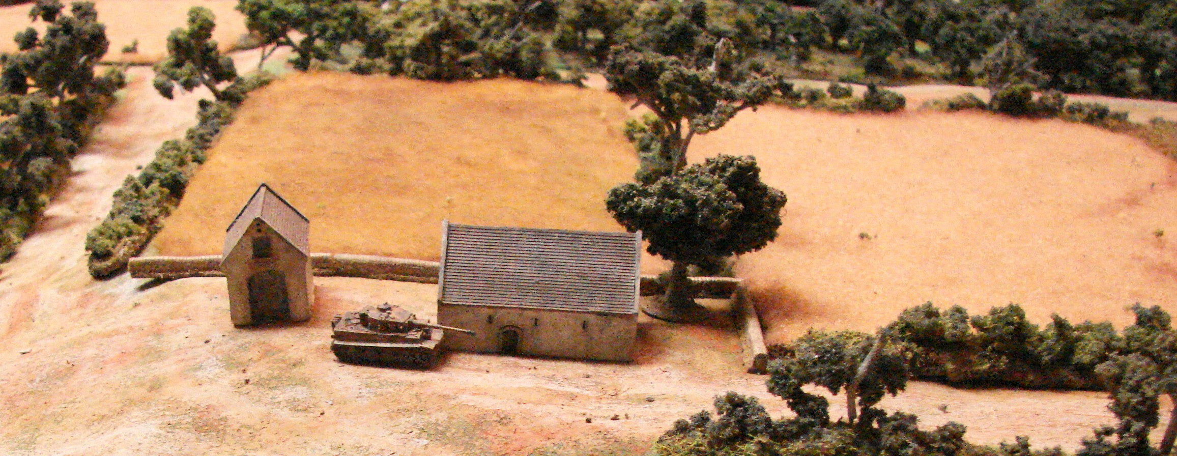 Stalled Tiger After coming on board, the Tiger just sat back at the farm for the rest of the game. If it moved up I'm sure it would've chewed up the remaining Shermans, since the Fireflys had already disappeared.